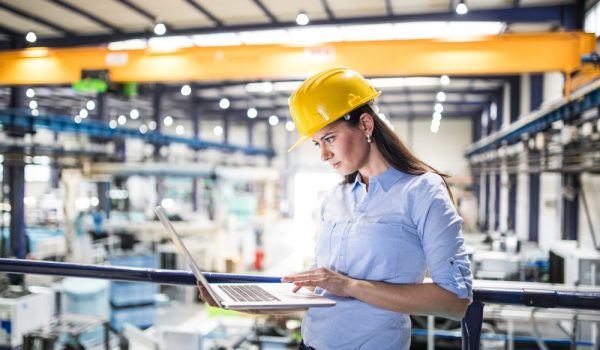 Female,Project,Manager,Standing,In,Modern,Industrial,Factory.,Manufacturing,Facility